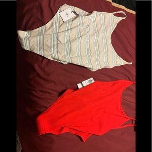 Two TNA Cozumel bodysuits